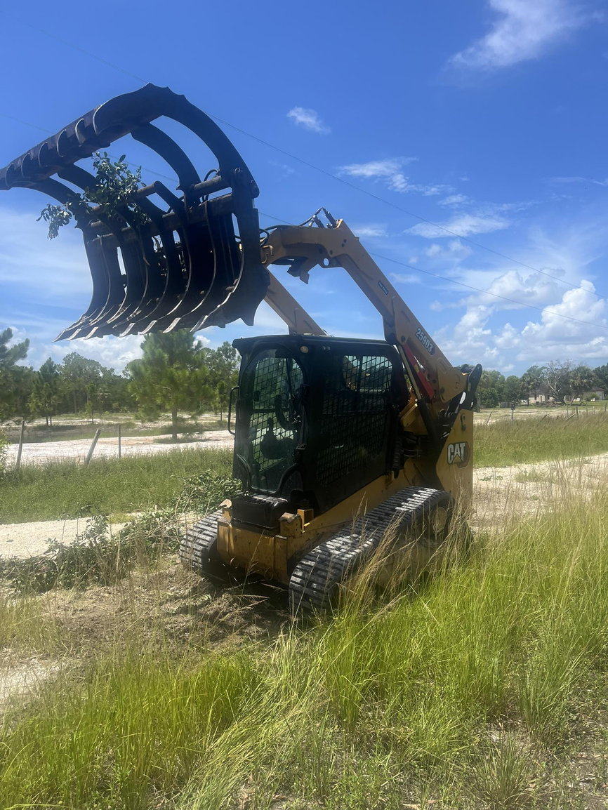Professional excavator with grapple attachment
