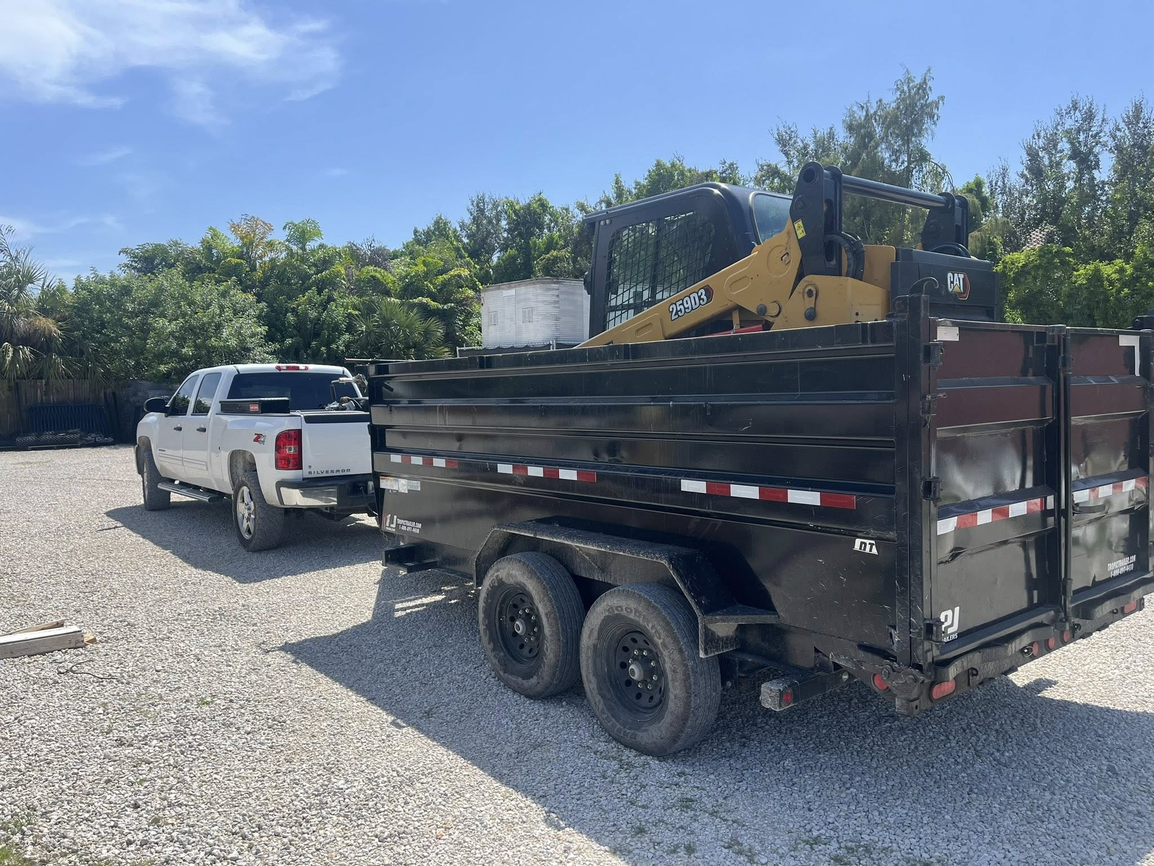 CAT skid steer on professional trailer